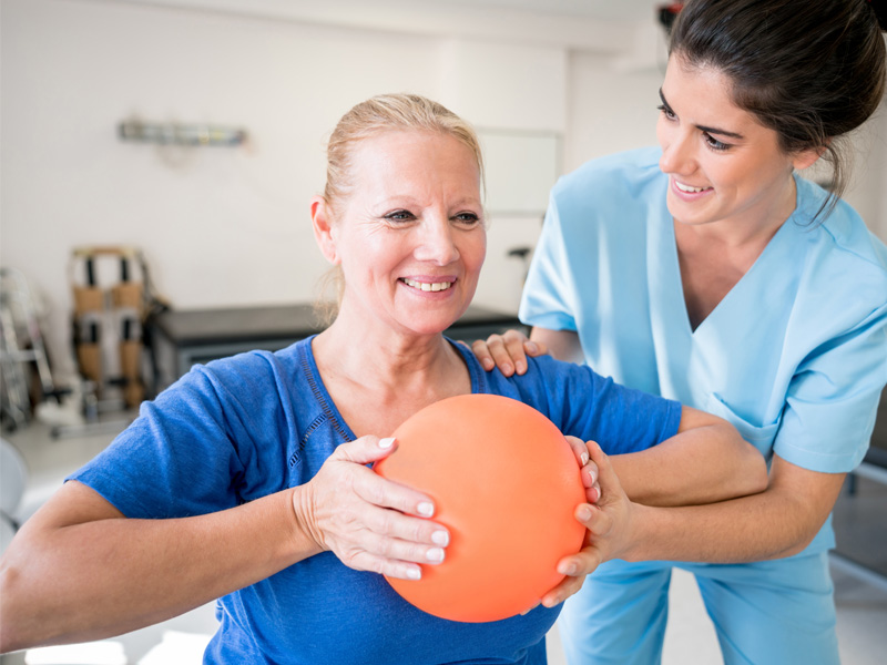 Woman doing physical therapy with nurse